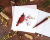 Carte de vœux cardinal rouge et fleurs de cerisier en papier roulé