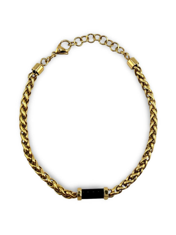 Bracelet Distingué ajustable 20–21,5 cm AJ&Co, finition dorée, avec détail noir et chaîne d’extension.