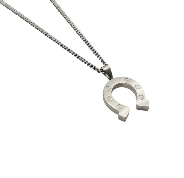 La Maison du Bleuet matte silver stainless steel horseshoe pendant necklace with a durable chain on marble surface