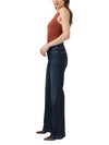 Maison Taïga Avery curvy fit high-rise trouser jeans in dark indigo denim with a slightly flared leg on a model.