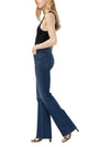 Maison Taïga Avery curvy high-waisted dark indigo bootcut jeans in power stretch denim worn by a model, side view.