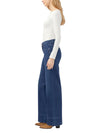 Model wearing Maison Taïga dark indigo wide leg Suki jeans with a mid-rise fit and soft power stretch denim fabric.