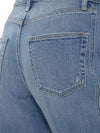 Close-up of Maison Taïga high-waisted barrel jeans in haze indigo denim showing back pocket detail and stitching