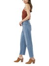 Model wearing Maison Taïga high-waisted barrel leg jeans in dark indigo denim with angled side seams and cropped hem.