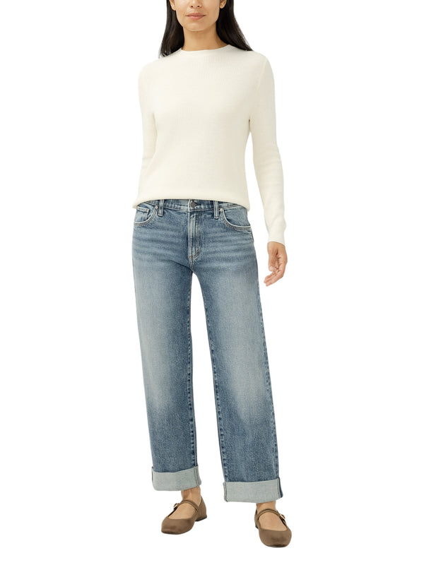 Maison Taïga mid-rise relaxed straight-leg jeans in medium indigo wash with cuffed ankles worn by a model