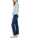 Maison Taïga Silver Jeans Co. women's dark indigo straight-leg jeans worn with a light blue sweater and white sneakers