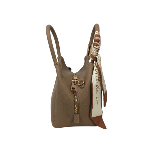 Maison Taïga taupe leather handbag with gold zipper and decorative patterned silk scarf tied to the handle